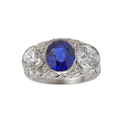 Early 20th century sapphire and diamond three stone ring, c.1915, centred by an oval facetted Burma sapphire of 2.80ct,